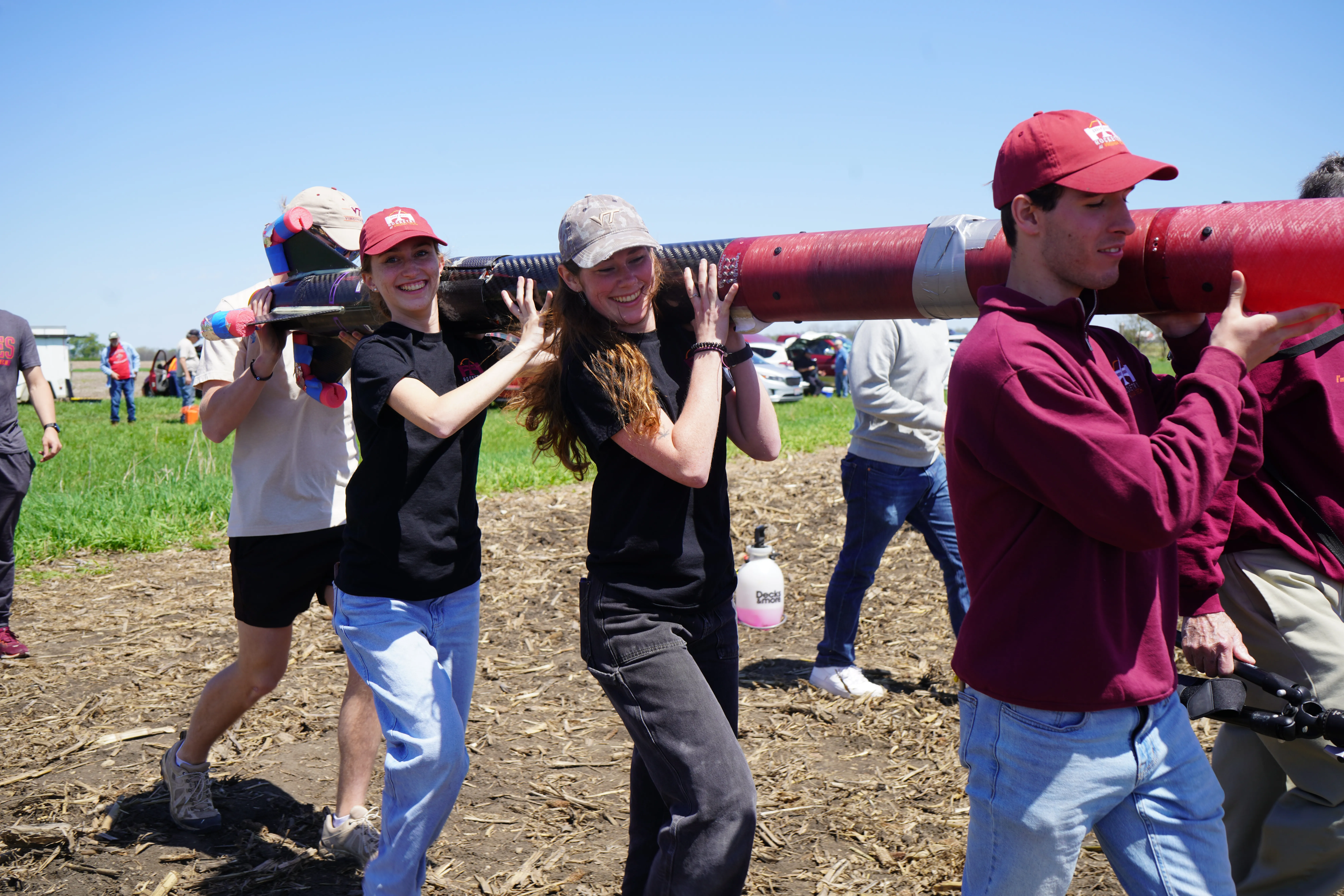 A Group shot of the Rocketry at Virginia Tech team holding the teams rocket