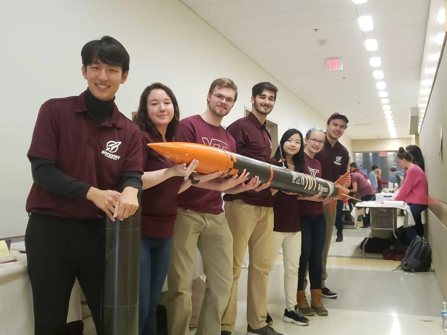 A Group shot of the Rocketry at Virginia Tech team holding the teams rocket